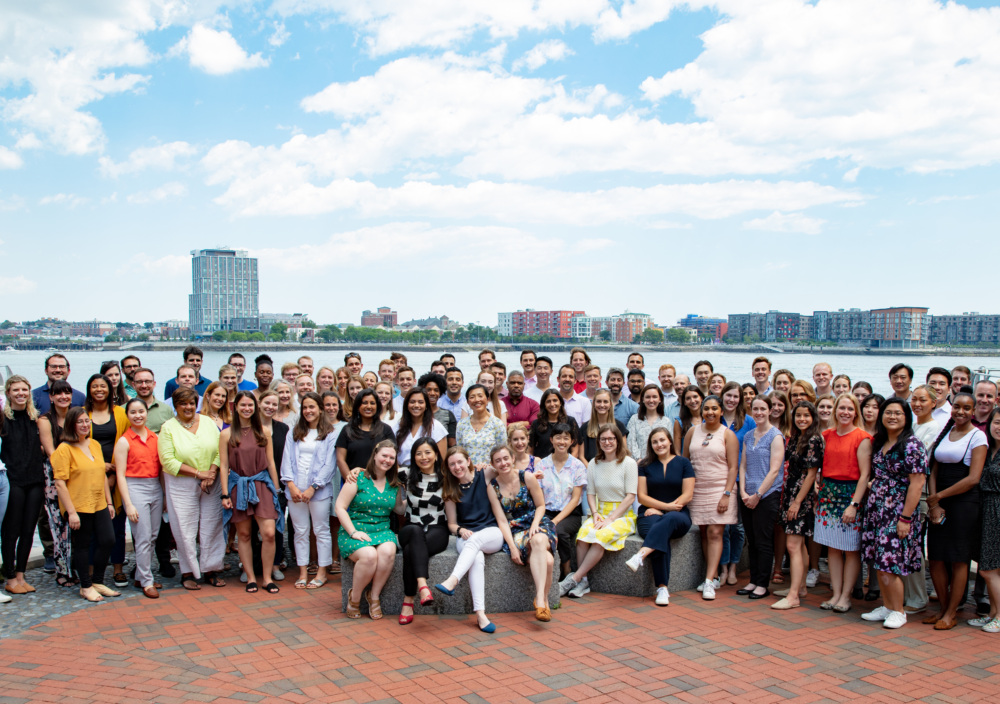 Group photo of everyone at Social Finance - Boston in front of the skyline.